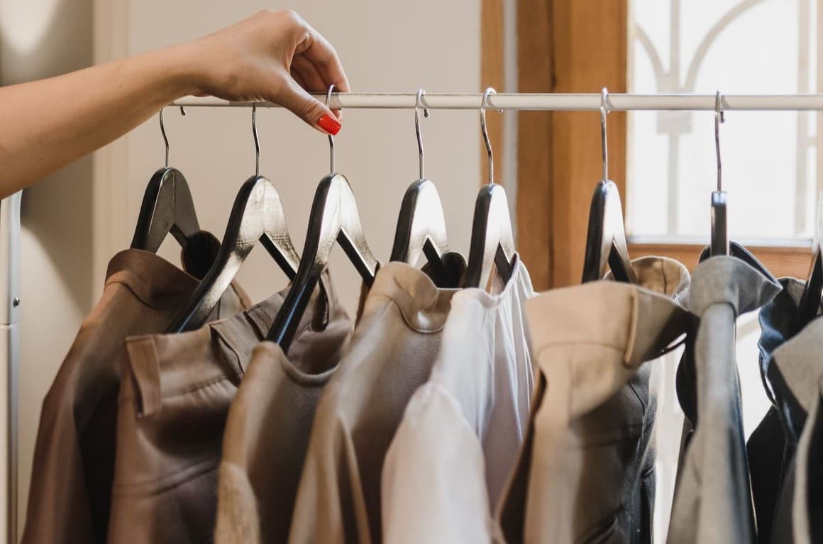 Leather and textile jackets on hangers on a clothing rack